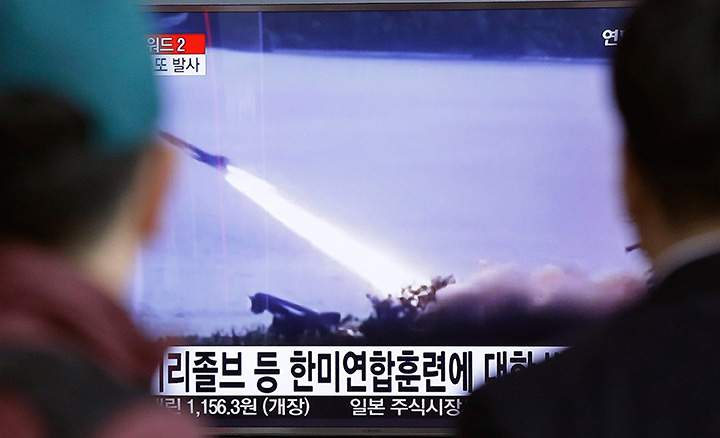 In this March 18, 2016 file photo, people watch a TV screen showing file footage of a missile launch conducted by North Korea, at Seoul Railway Station South Korea. 