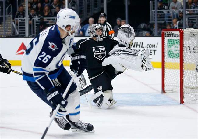 Winnipeg Jets right wing Blake Wheeler, left, watches as he misses a shot-attempt while Los Angeles Kings goalie Jonathan Quick, right, protects the net during the first period of an NHL hockey game, Saturday, April 9, 2016, in Los Angeles.