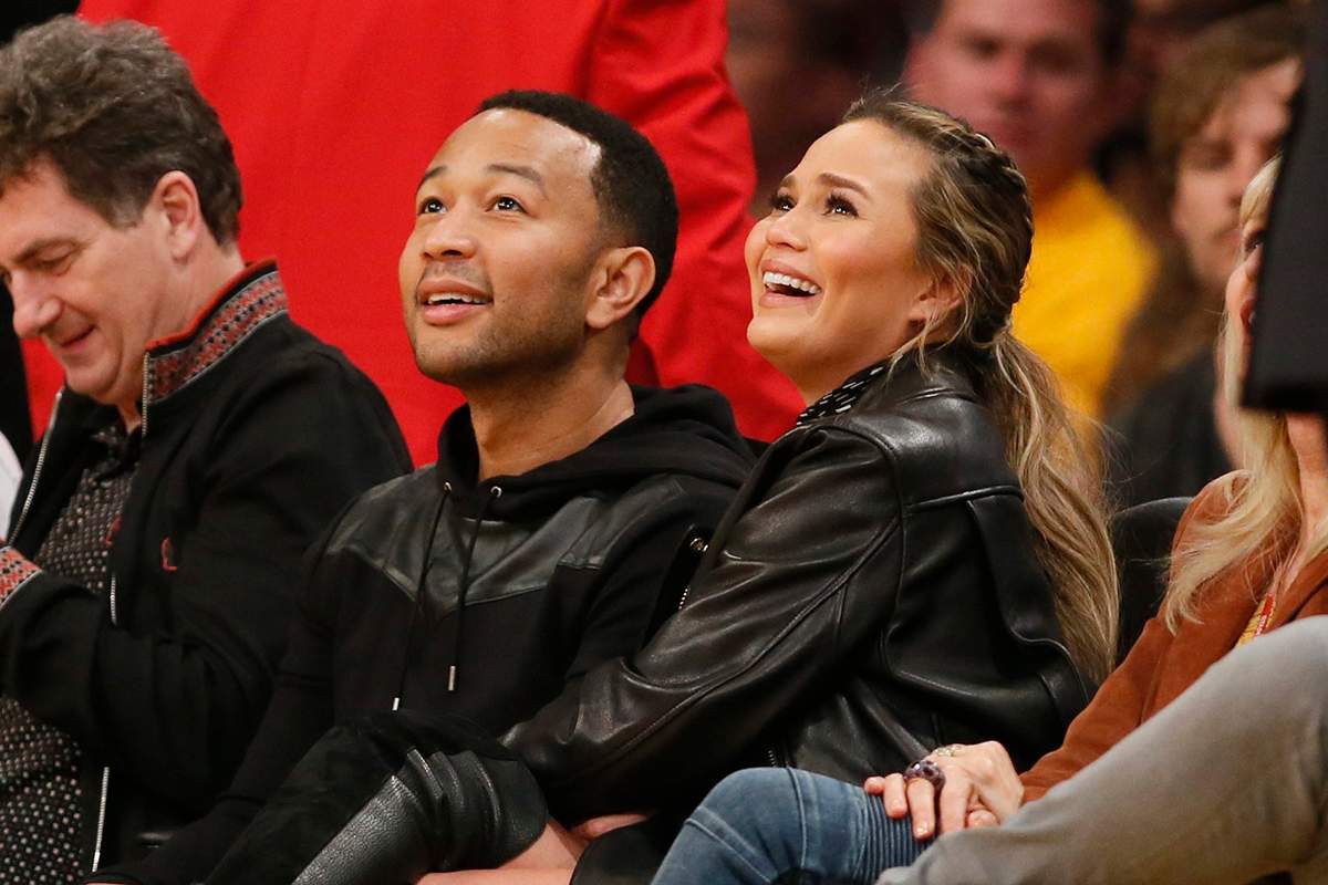  In a Thursday, March 10, 2016 file photo, musician John Legend, left, and model Chrissy Teigen, right, sit courtside during the first half of an NBA basketball game between the Los Angeles Lakers and Cleveland Cavaliers, in Los Angeles.