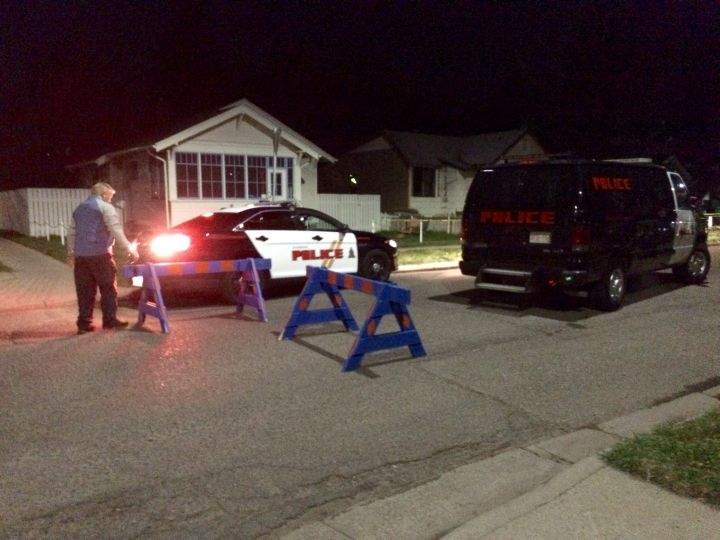 A heavy police presence surrounds a home on 15 Street North in Lethbridge, Alta. on April 15, 2016.