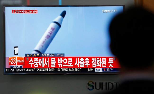 North Korea on Saturday fired what appeared to be a ballistic missile from a submarine off its northeast coast, South Korean defense officials said, Pyongyang's latest effort to expand its military might in the face of pressure by its neighbors and Washington. The Korean letters at top left read: "North Korea fires a submarine-launched ballistic missile or SLBM."