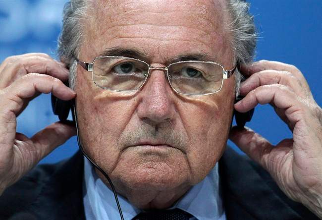 In this June 1, 2011 file photo, Sepp Blatter adjusts his headphones during a press conference after the 61st FIFA Congress in Zurich, Switzerland. 