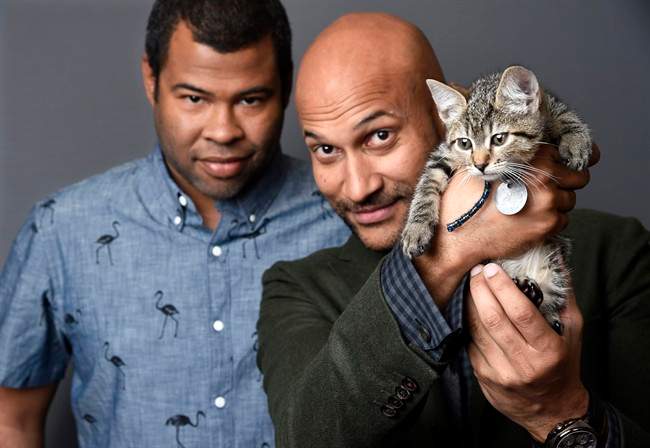 Jordan Peele, left, and Keegan-Michael Kay hold a ten-week-old tabby as they pose for a portrait to promote their film, "Keanu," at The Beverly Hilton Hotel in Beverly Hills, Calif.