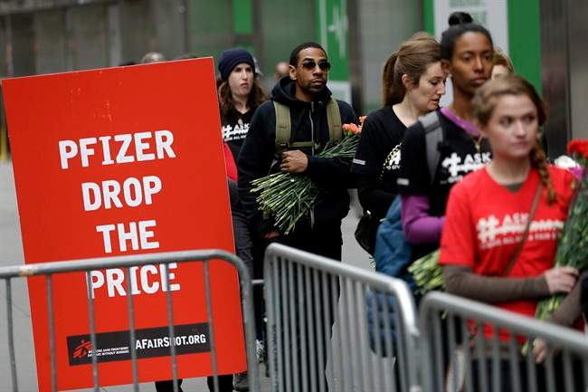 Activists line up to put flowers in crib in front of Pfizer world headquarters in New York, Wednesday, April 27, 2016. The crib filled with flowers, organized by Doctors Without Borders, was delivered to Pfizer with a petition demanding that the pharmaceutical company lower the cost of the pneumonia vaccine.
