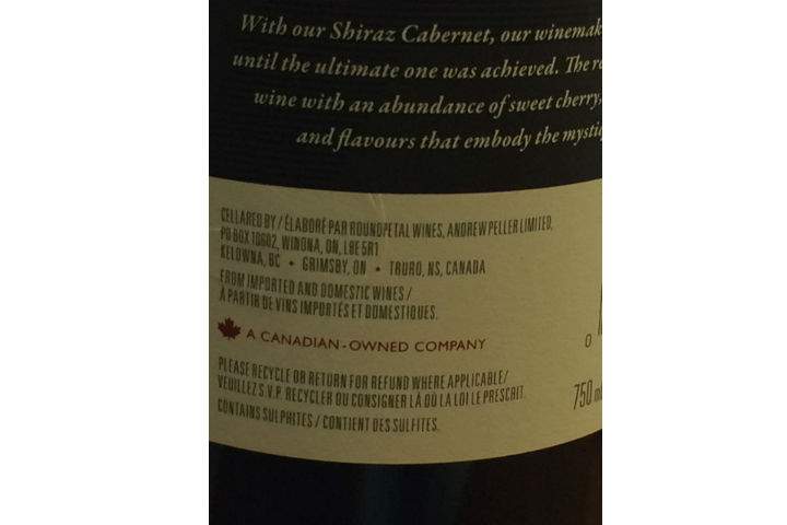A label on a bottle of “Cellared in Canada” wine produced by an Andrew Peller Ltd. winery, stating it is a blend of international and domestic wines.