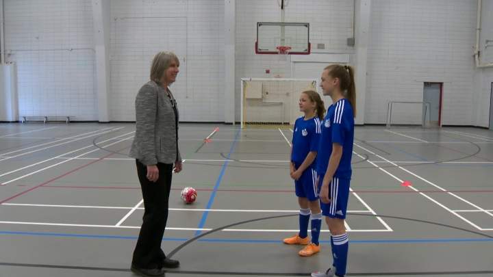 U of C researcher Carolyn Emery with Calgary sisters Emma and Myla Schneider.