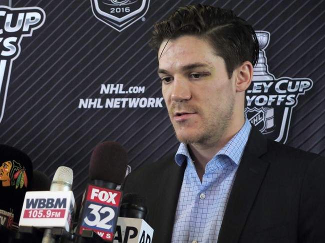 Chicago Blackhawks forward Andrew Shaw talks to reporters before the team left for St. Louis on Wednesday, April 20, 2016, at Chicago's O'Hare International Airport.