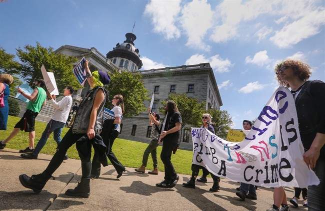 The Trans Student Alliance at University of Southern California holds a rally and news conference at the state Capitol to protest a controversial bill that would ban transgender people from choosing the bathroom they use Wednesday, April 13, 2016, in Columbia, S.C. 