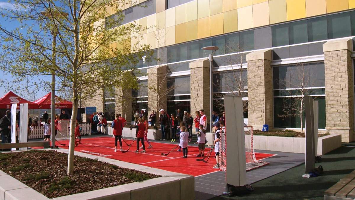 Kids play hockey on an outdoor sports pad at the South Health Campus YMCA.