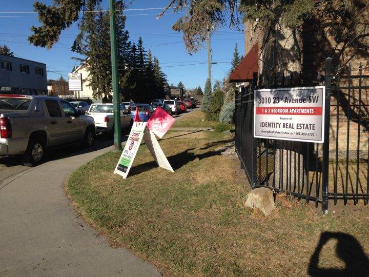 Street cleaning sign on southwest Calgary street corner