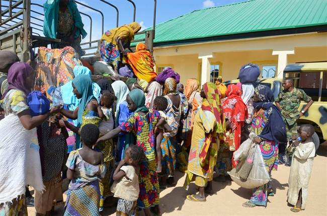 Women and children rescued by Nigerian soldiers from Boko Haram arrive in a military office in Maiduguri, Nigeria in this July 30, 2015 file photo.