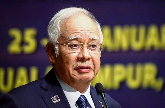 In this Monday, Jan. 25, 2016 file photo, Malaysian Prime Minister Najib Razak delivers his opening speech at a conference in Kuala Lumpur, Malaysia.