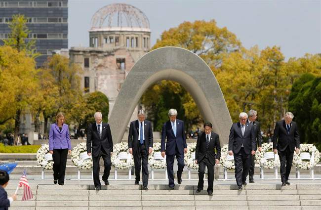 G7 foreign ministers, from left to right, E.U. High Representative for Foreign Affairs Federica Mogherini, Canada's Foreign Minister Stephane Dion, Britain's Foreign Minister Philip Hammond, U.S. Secretary of State John Kerry, Japan's Foreign Minister Fumio Kishida, Germany's Foreign Minister Frank-Walter Steinmeier, Italy's Foreign Minister Paolo Gentiloni and France's Foreign Minister Jean-Marc Ayrault walk together after placing wreaths at the cenotaph at Hiroshima Peace Memorial Park in Hiroshima, western Japan, Monday, April 11, 2016. (Jonathan Ernst/Pool Photo via AP).