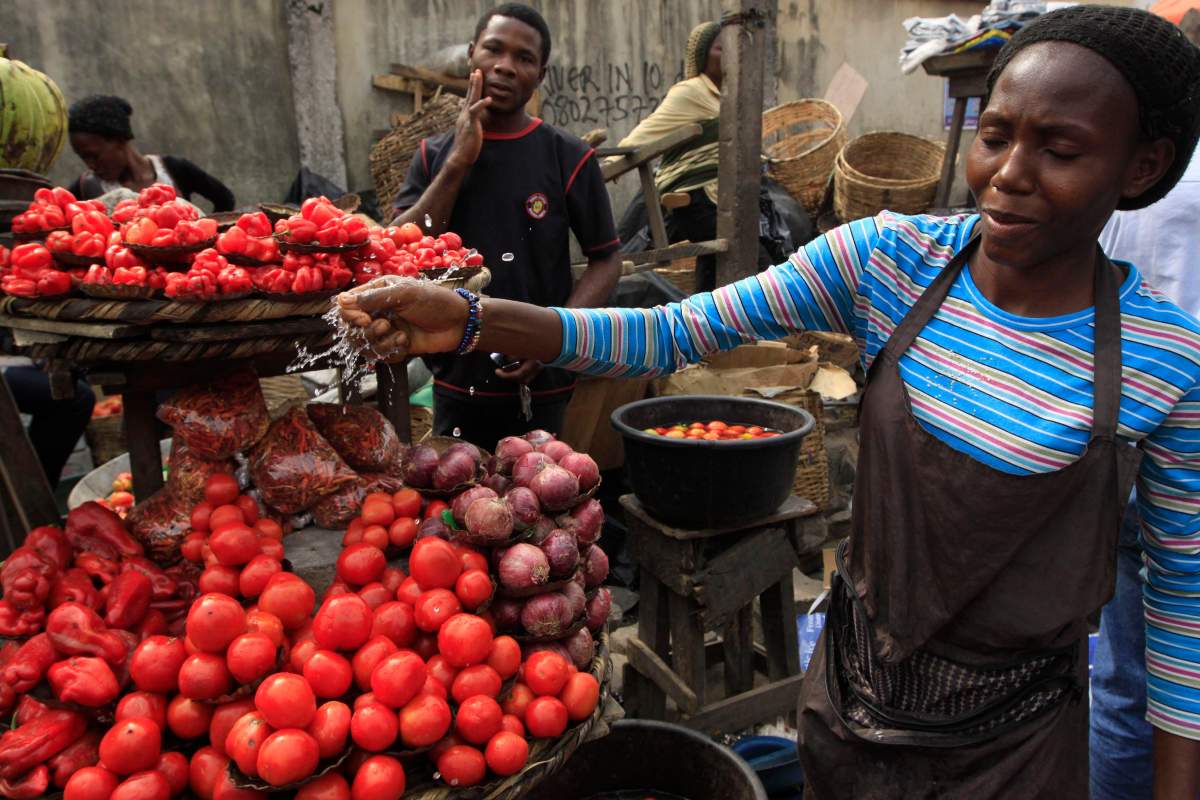 Women sells tomatoes at a market in Obalende, Lagos, Nigeria, Saturday, Jan. 14, 2012. 