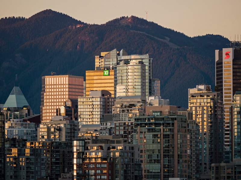 Sunset colours reflect off the glass of Vancouver's crowded downtown skyline, .