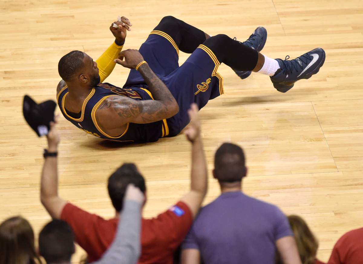 Cleveland Cavaliers's LeBron James falls to the floor after being hit by teammate Tristan Thompson during first half Eastern Conference final NBA playoff basketball action against the Toronto Raptors in Toronto on Saturday, May 21, 2016. 