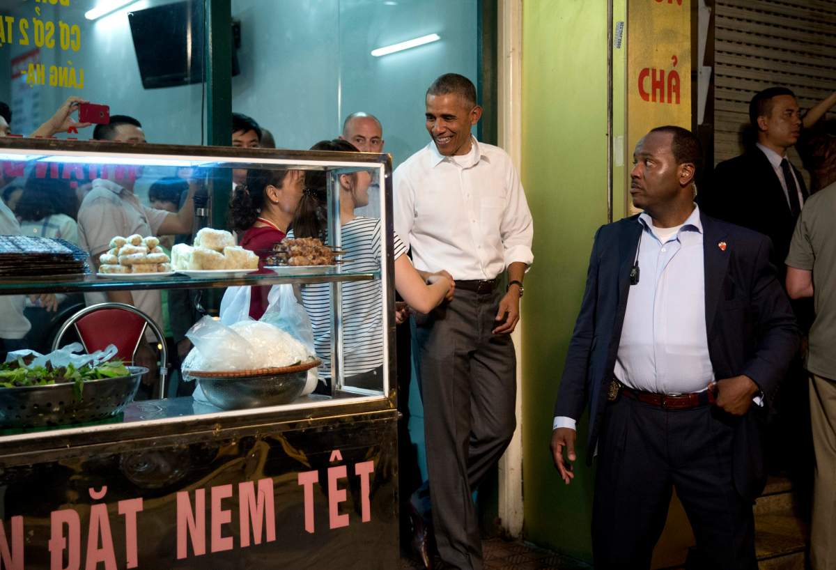 President Barack Obama greets people at the door as he walks from the Bún ch? Huong Liên restaurant after having dinner with American Chef Anthony Bourdain, Monday, May 23, 2016, in Hanoi, Vietnam.