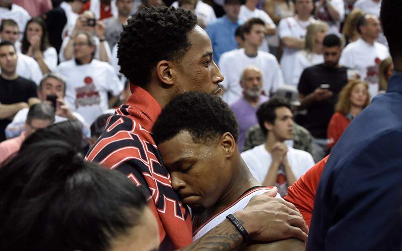 Toronto Raptors guard DeMar DeRozan, left, hugs teammate Kyle Lowry after the Eastern Conference final NBA playoff basketball game against the Cleveland Cavaliers in Toronto on Friday, May 27, 2016. 