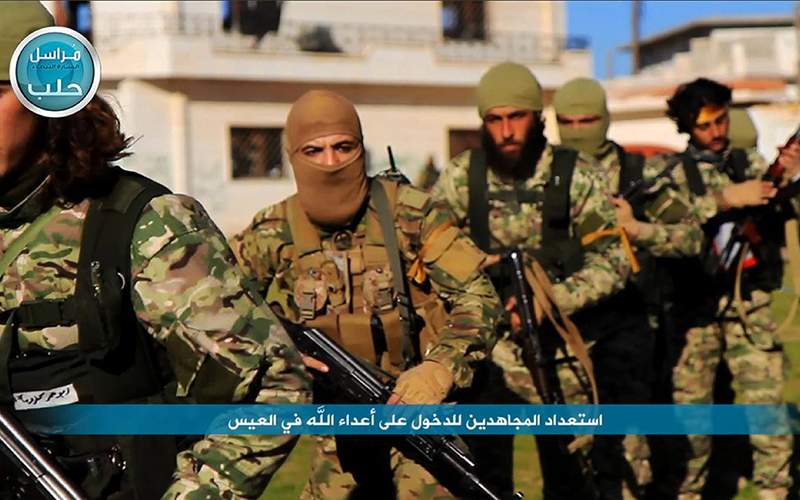 An image posted on the Twitter page of Syria's al-Qaida-linked Nusra Front showing fighters marching toward the northern village of al-Ais in Aleppo province, Syria. 