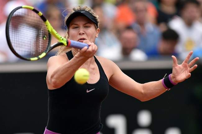Eugenie Bouchard returns the ball to Angelique Kerber of Germany during their match at the Italian Open tennis tournament, in Rome, Wednesday, May 11, 2016.