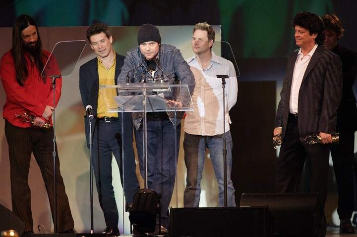Gord Downie speaks as members of The Tragically Hip look on as the band is inducted into the hall of fame at the Juno Gala awards in Winnipeg, Saturday April 2, 2005.