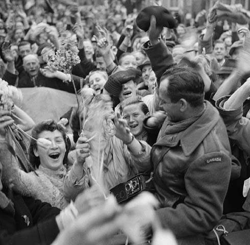 Crowd of Dutch civilians celebrating the liberation of Utrecht by the Canadian Army, May 7, 1945.