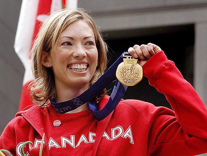 Canadian cross-country skier Beckie Scott displays her gold medal she was awarded at a ceremony in Vancouver on June 25, 2004. 