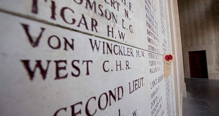 A wooden remembrance with a poppy is placed near names of the missing on the Menin Gate in Ypres, Belgium on Thursday, June 26, 2014. 