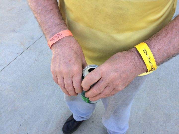 Peter Callaghan sports wristbands for both evacuation centres he has stayed at. Orange is for Anzac while yellow is for Northlands.