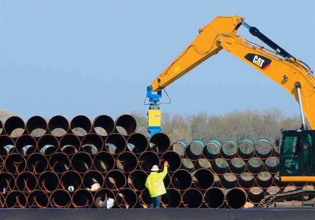 FILE – In this May 9, 2015 file photo, pipes for the proposed Dakota Access oil pipeline that will stretch from the Bakken oil fields in North Dakota to Illinois are stacked at a staging area in Worthing, S.D.