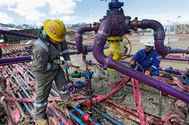File photo of a worker tending a well head.