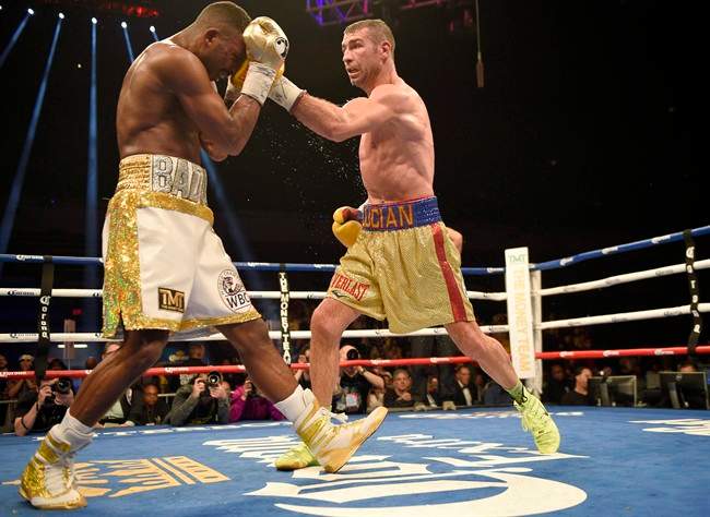 Lucian Bute, right, hits Badou Jack with a left during a boxing bout early Sunday, May 1, 2016, in Washington. Montreal boxer Lucian Bute says he is "surprised and saddened" to learn he had failed a doping test after his super middleweight title bout against Badou Jack. The World Boxing Council said Thursday that the D.C. Boxing and Wrestling commission revealed it found the banned substance Ostarine.