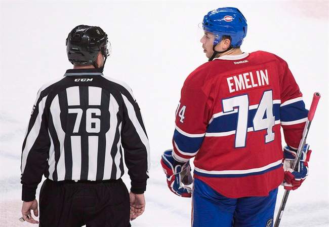 Montreal Canadiens' defender Alexei Emelin talks with linesman Michel Cormier after he was given a game misconduct during first period NHL hockey action against the Columbus Blue Jackets, in Montreal, on Dec. 1, 2015. Russia added Emelin of the Montreal Canadiens to their final 23-man roster for the World Cup of Hockey. THE CANADIAN PRESS/Graham Hughes.