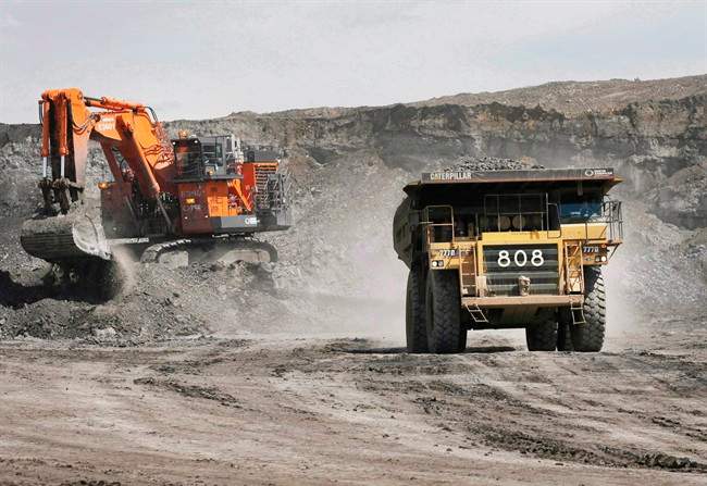 File: A haul truck carrying a full load drives at the Shell Albian Sands oilsands mine near Fort McMurray, Alta., on July 9, 2008. 
