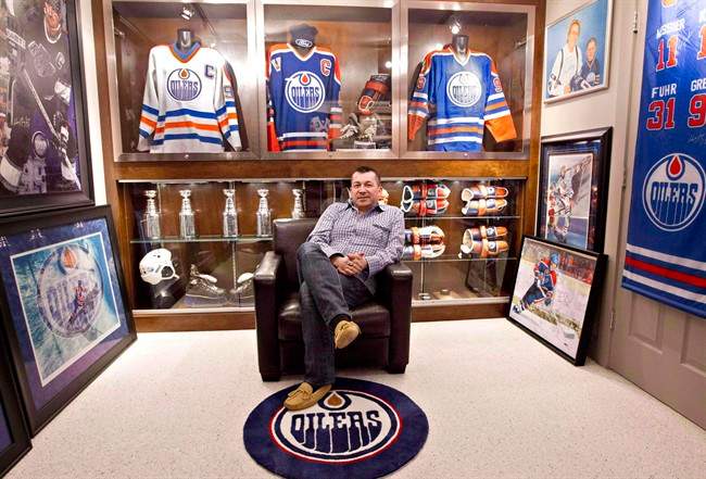 Shawn Chaulk poses with his collection of Wayne Gretzky memorabilia in Fort McMurray, Alta., on April 16, 2013. Chaulk, one of Canada's biggest collectors of hockey memorabilia, says the Fort McMurray fire may have changed his attitude toward collecting. 