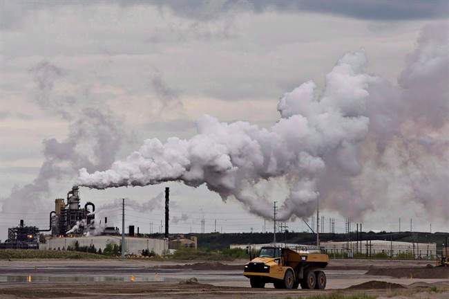 A dump truck works near the Syncrude oil sands extraction facility near the city of Fort McMurray, Alta., on June 1, 2014. A new study in the journal Nature finds that Alberta's oil sands are one of the largest sources of organic aerosol air pollution in North America. 