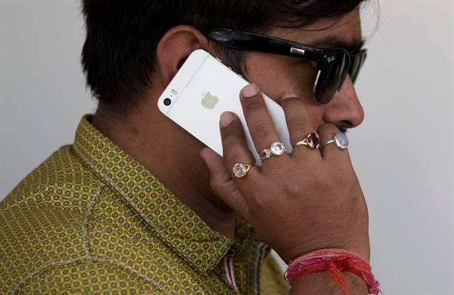 An Indian man talks on his iPhone in New Delhi, India.