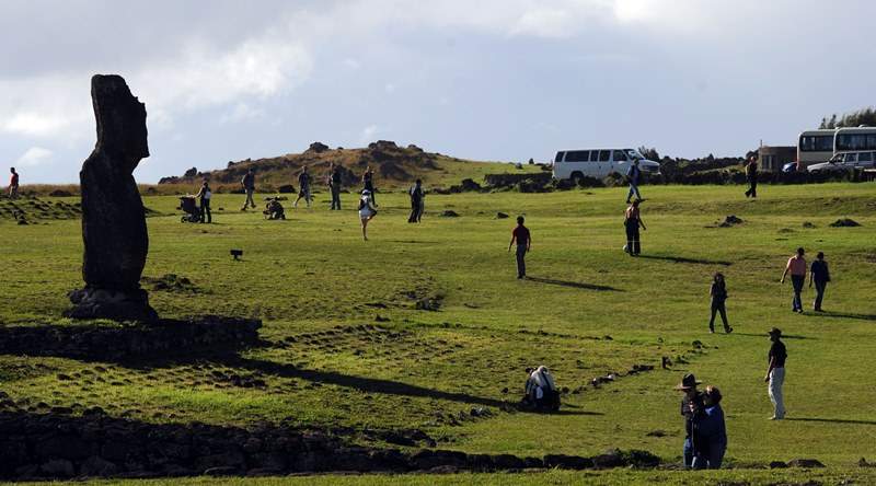 Tourists take pictures of Moais -- stone statue of the Rapa Nui culture -- on Easter Island, 3700 km off the Chilean coast in the Pacific Ocean, on July 9, 2010. 