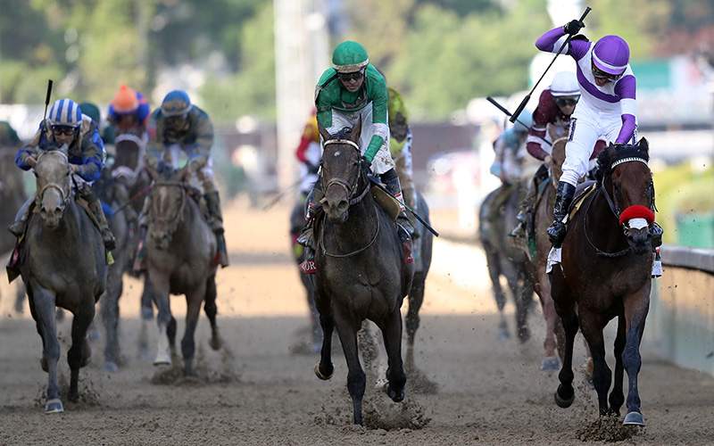 Mario Gutierrez celebrates atop Nyquist #13 after crossing the finish line to win the 142nd running of the Kentucky Derby at Churchill Downs on May 07, 2016 in Louisville, Kentucky. 