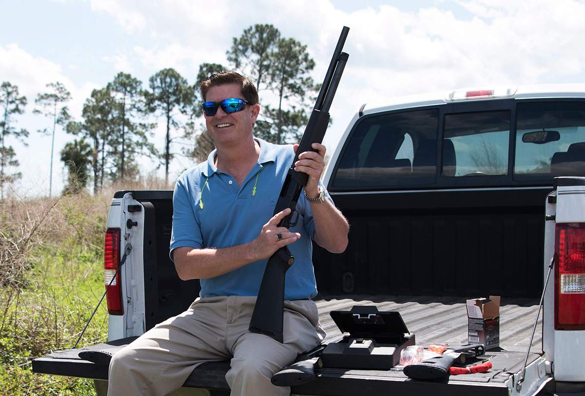 In this photo taken April 7, 2016, Jonathan Mossberg, whose iGun Technology Corp. is working to develop a "smart gun," poses with the firearm, in Daytona Beach, Fla. 
