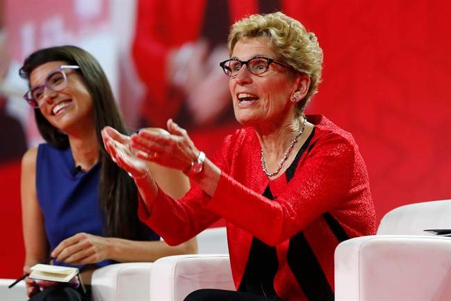 Ontario Premier Kathleen Wynne, right, speaks to Liz Plank onstage at the 2016 Liberal Biennial Convention in Winnipeg, Saturday, May 28, 2016.