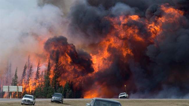 A giant fireball is seen as a wildfire rips through the forest along Highway 63, 16kilometres south of Fort McMurray, Alta., Saturday, May 7, 2016. 