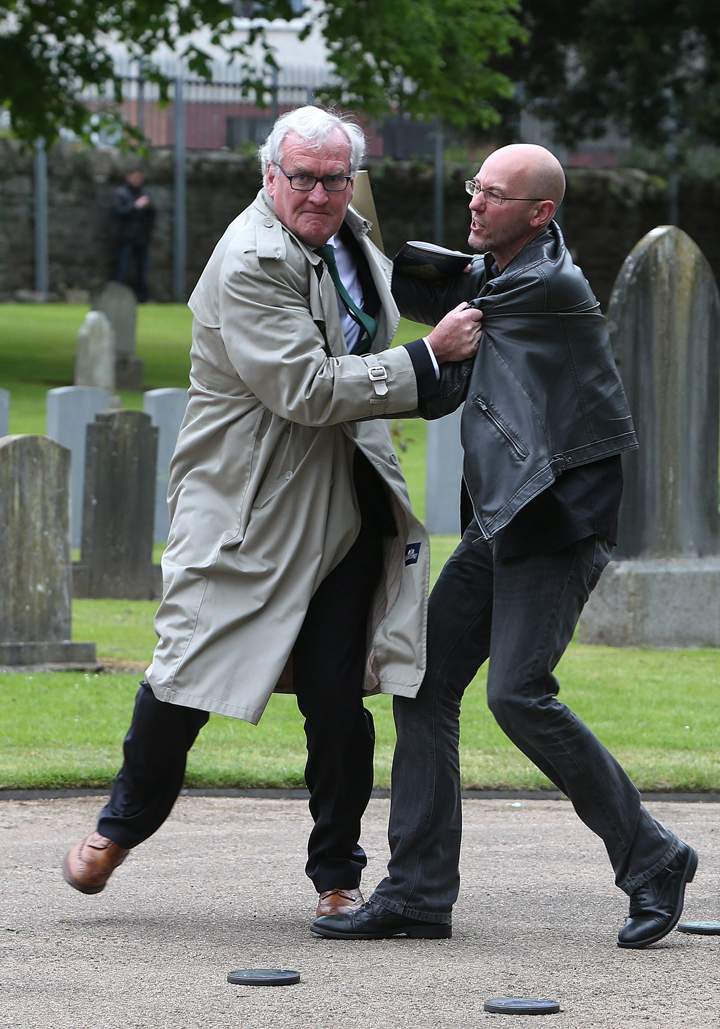 Canadian Ambassador to Ireland Kevin Vickers, left, wrestles with a protester