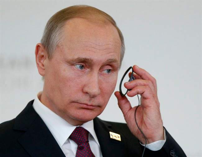 Russian President Vladimir Putin attends a joint news conference.