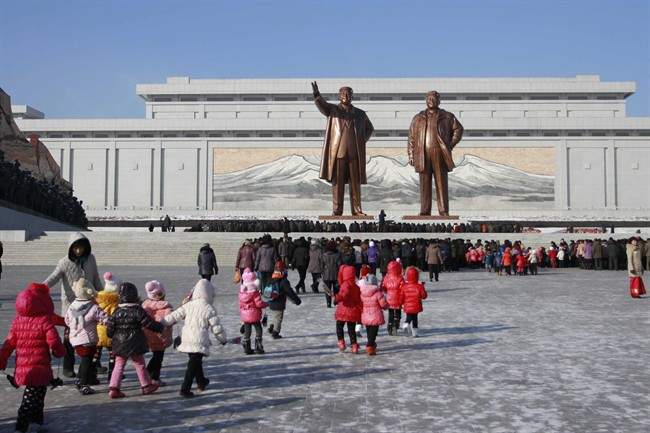 In this Dec. 16, 2014 file photo, North Koreans gather at the Mansu Hill where the statues of the late leaders Kim Il Sung, and Kim Jong Il tower over them, in Pyongyang, North Korea.