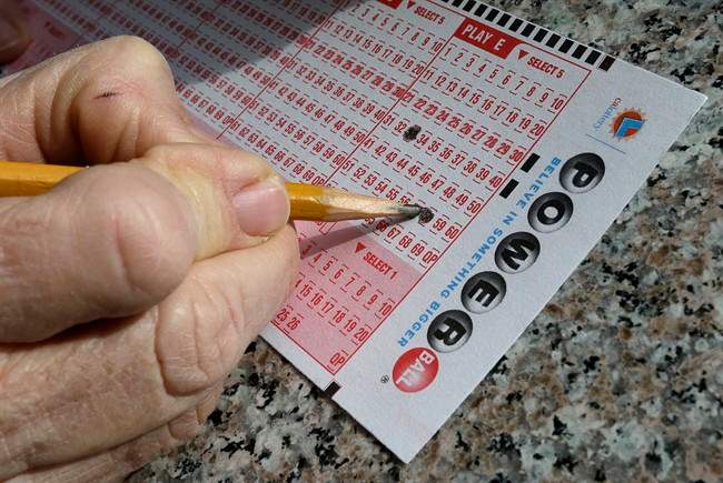  In this Jan. 12, 2016 file photo, a lottery player fills out numbers on a powerball form in Oakland, Calif.