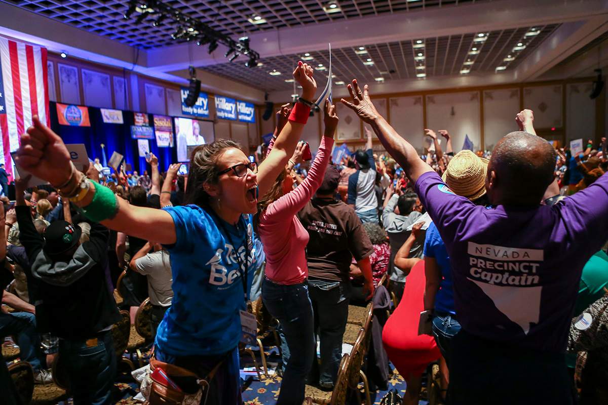 In a Saturday, May 14, 2016 photo, supporters of Democratic presidential candidate Bernie Sanders react during the Nevada State Democratic Party’s 2016 State Convention at the Paris hotel-casino in Las Vegas.