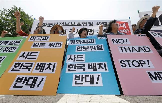 South Korean protesters stage a rally denouncing the United States, South Korean and Japanese governments' missile policies on North Korea in front of the Defense Ministry in Seoul, South Korea, Tuesday, May 31, 2016.