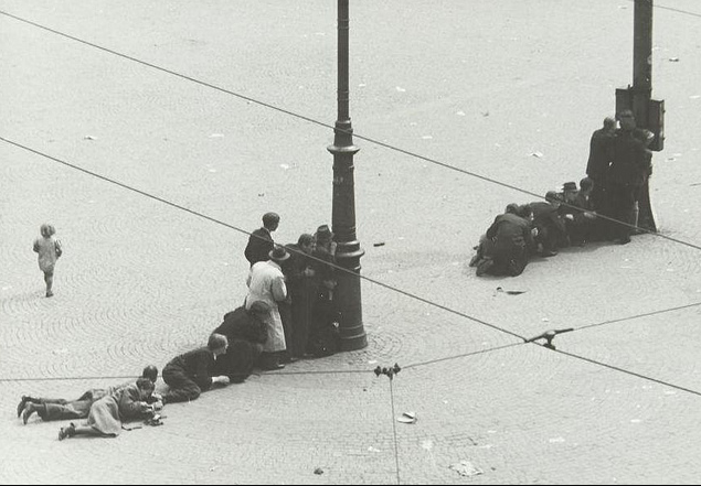 Dutch civilians hide from German snipers in Amsterdam. May, 1945.