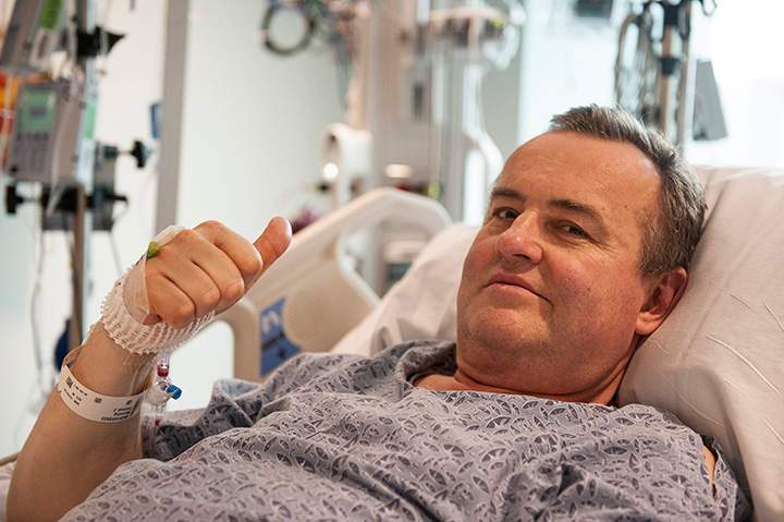 In this May 13, 2016 photo provided by Massachusetts General Hospital, Thomas Manning gives a thumbs up after being asked how he was feeling following the first penis transplant in the United States, in Boston.